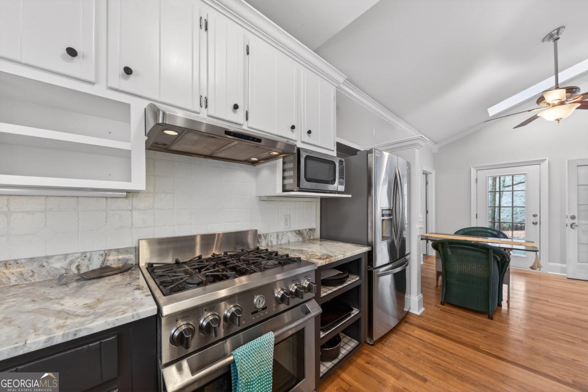 1091 Maple Ridge Way Greensboro, GA 30642 - Photo 17 of 52 a kitchen with stainless steel appliances granite countertop a stove and a refrigerator