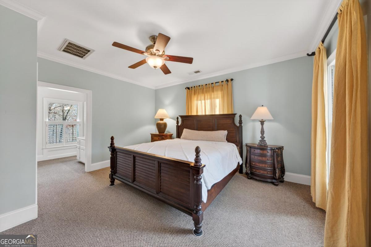 1091 Maple Ridge Way Greensboro, GA 30642 - Photo 19 of 52 a bedroom with a bed chandelier and a window