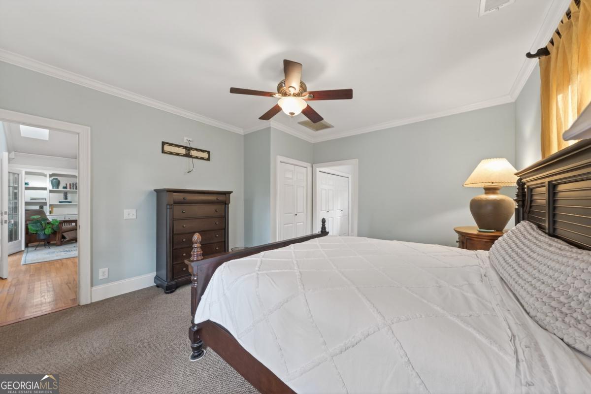 1091 Maple Ridge Way Greensboro, GA 30642 - Photo 20 of 52 a bedroom with a bed and a chandelier