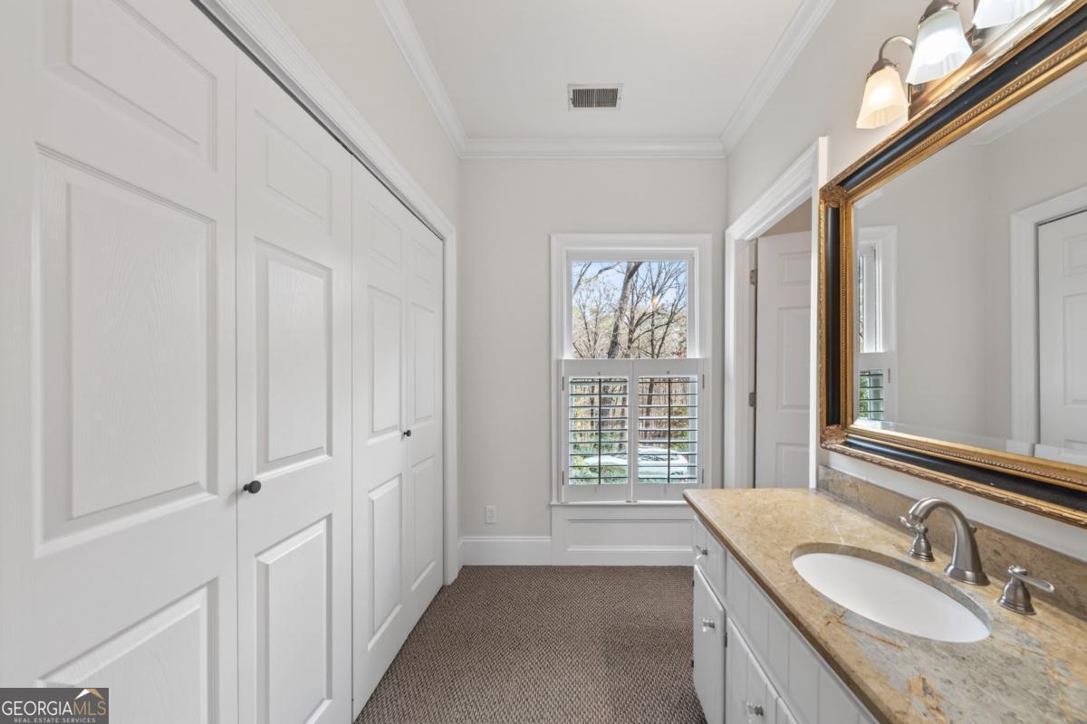 1091 Maple Ridge Way Greensboro, GA 30642 - Photo 21 of 52 a bathroom with a granite countertop sink and a mirror