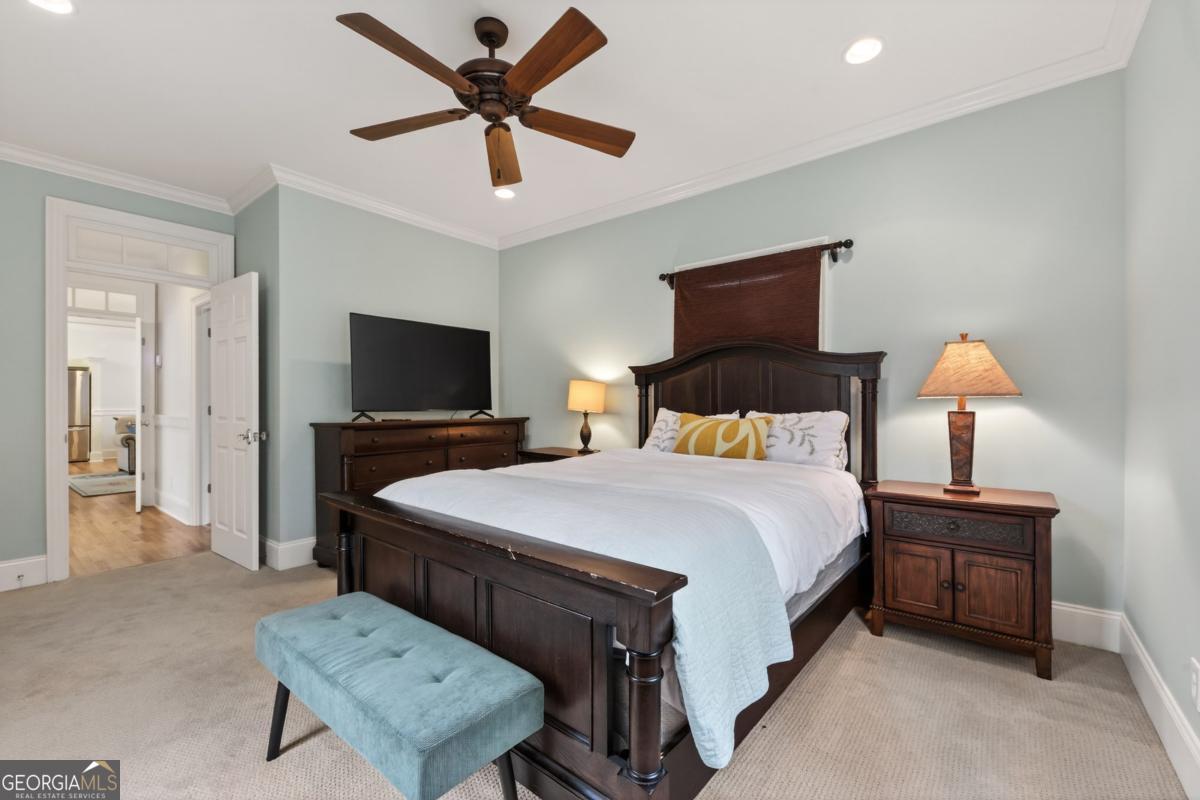 1091 Maple Ridge Way Greensboro, GA 30642 - Photo 23 of 52 a bedroom with a bed and a flat screen tv