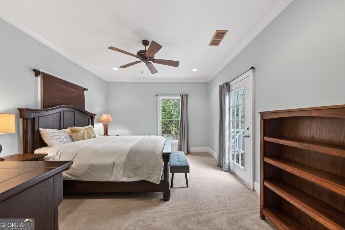 1091 Maple Ridge Way Greensboro, GA 30642 - Photo 24 of 52 a bedroom with a bed and a chandelier