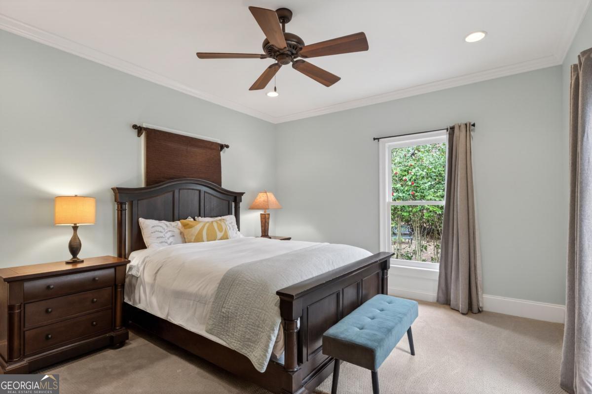 1091 Maple Ridge Way Greensboro, GA 30642 - Photo 25 of 52 a bedroom with a bed and a chandelier