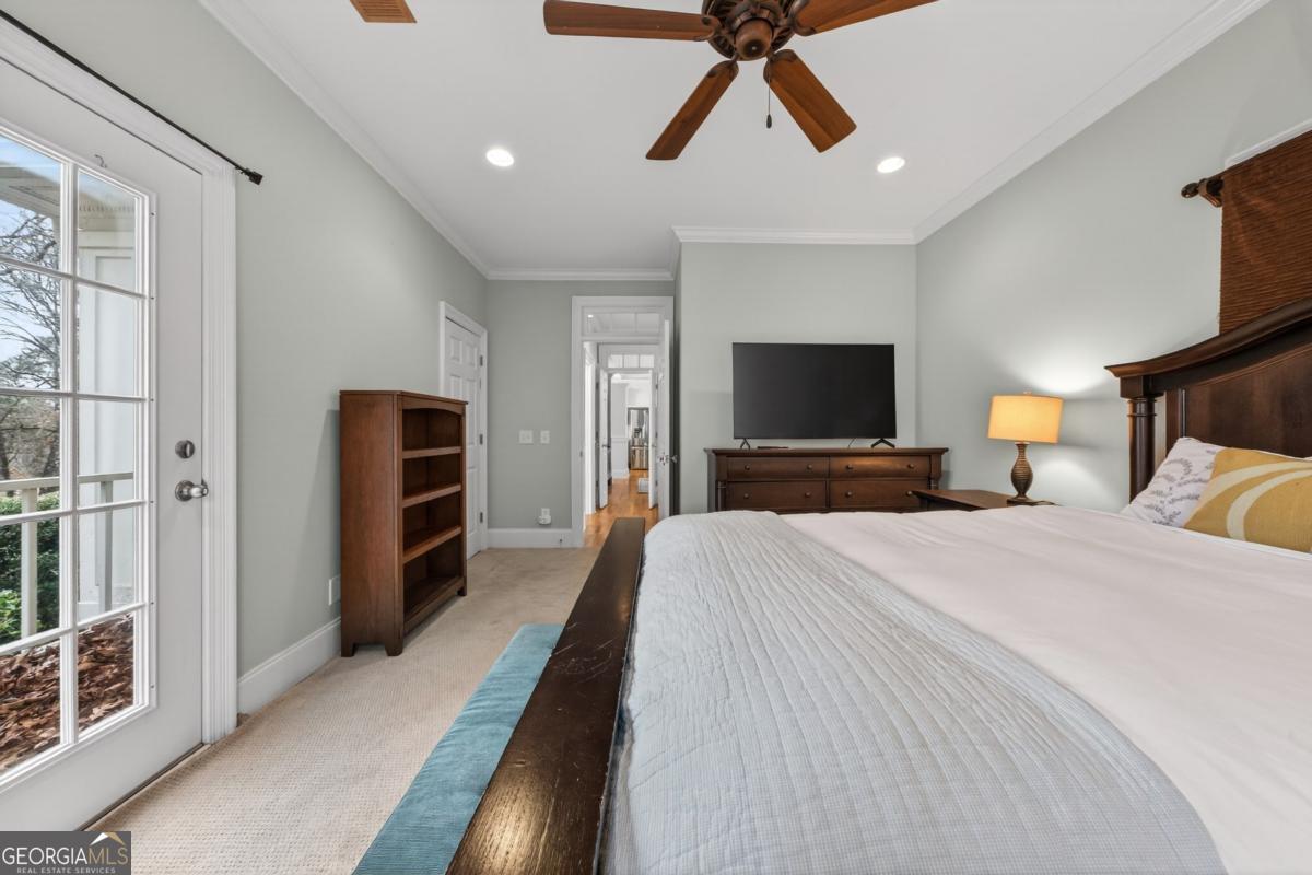 1091 Maple Ridge Way Greensboro, GA 30642 - Photo 26 of 52 a bedroom with a bed and a flat screen tv