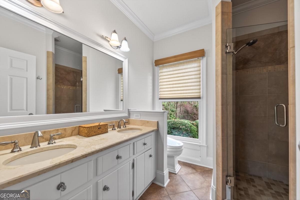 1091 Maple Ridge Way Greensboro, GA 30642 - Photo 27 of 52 a spacious bathroom with a granite countertop sink and a mirror