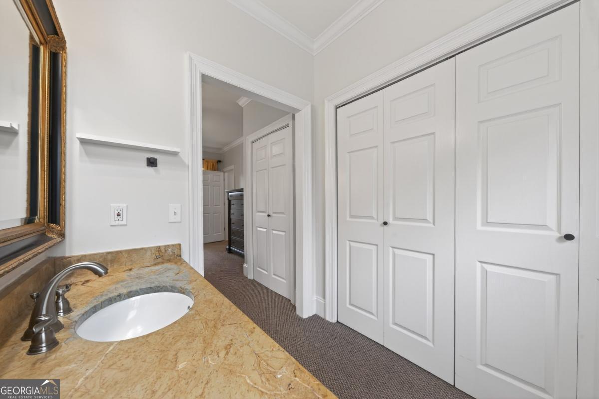 1091 Maple Ridge Way Greensboro, GA 30642 - Photo 28 of 52 a bathroom with a granite countertop double vanity sink and a mirror