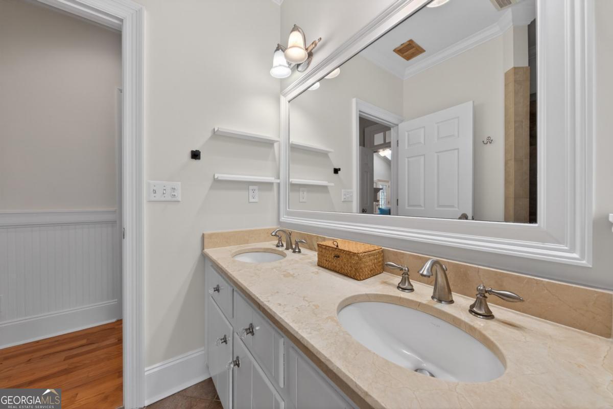 1091 Maple Ridge Way Greensboro, GA 30642 - Photo 29 of 52 a bathroom with a sink a vanity and a mirror