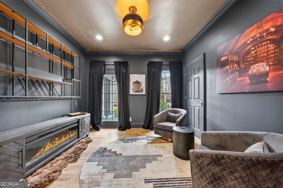 1091 Maple Ridge Way Greensboro, GA 30642 - Photo 31 of 52 a living room with furniture and a book shelf