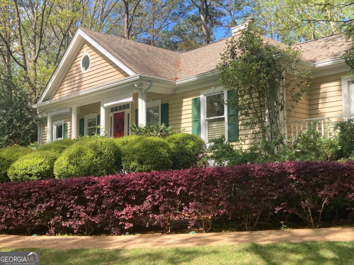 1091 Maple Ridge Way Greensboro, GA 30642 - Photo 36 of 52 a front view of a house with a garden