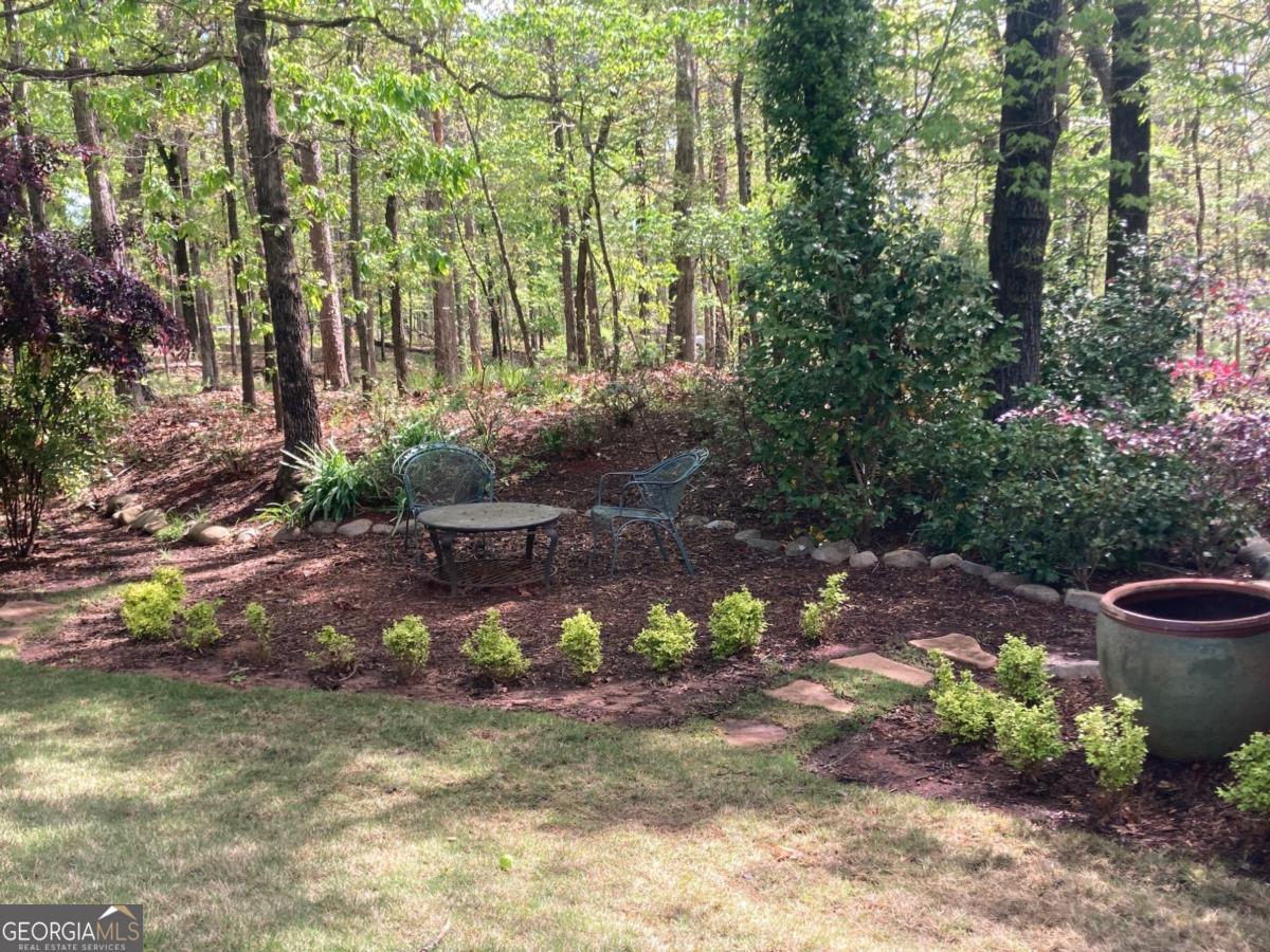1091 Maple Ridge Way Greensboro, GA 30642 - Photo 37 of 52 a view of a garden with a fountain