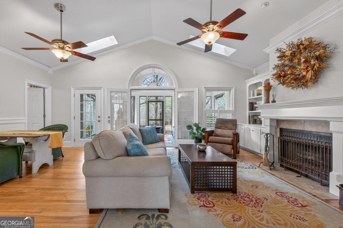 1091 Maple Ridge Way Greensboro, GA 30642 - Photo 5 of 52 a living room with furniture a fireplace and a chandelier