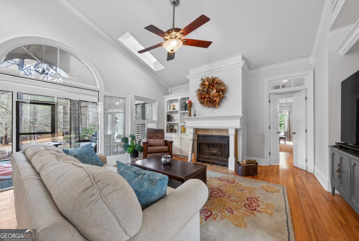 1091 Maple Ridge Way Greensboro, GA 30642 - Photo 6 of 52 a living room with furniture a fireplace and a flat screen tv