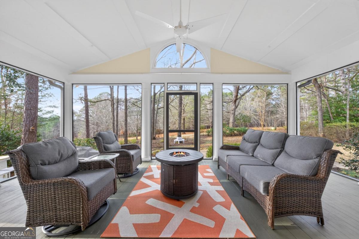 1091 Maple Ridge Way Greensboro, GA 30642 - Photo 9 of 52 a living room with furniture and a floor to ceiling window