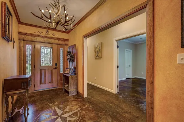 a view of empty room with hallway and wooden floor
