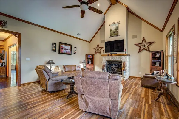 a living room with furniture a flat screen tv and a fireplace