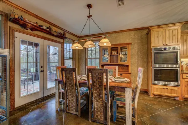 a view of a dining room with furniture and chandelier