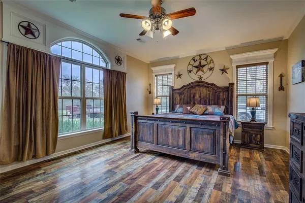 a view of bedroom with furniture window and wooden floor