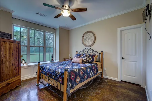 a bedroom with a bed and a window