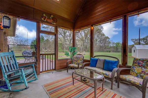 a outdoor living space with furniture and a floor to ceiling window