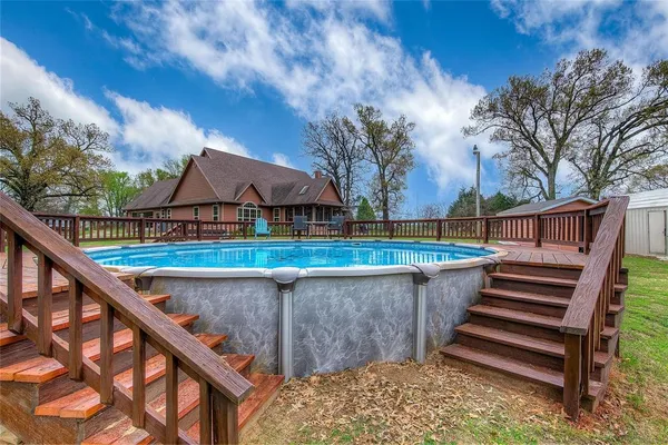 a view of swimming pool with deck and lake view