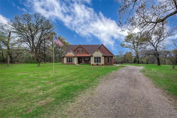 a view of green field with house in the background