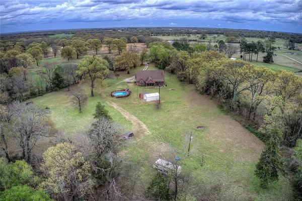 an aerial view of a house with a yard