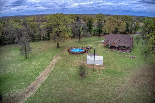 a view of a backyard with lawn chairs and a fire pit