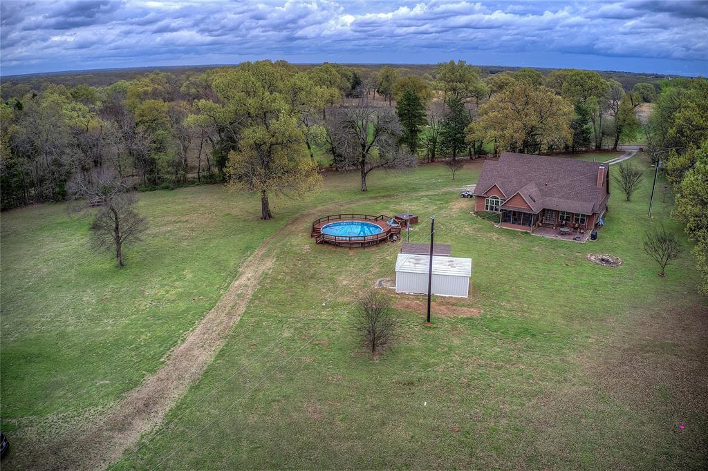 811 County Road 4250 Point, TX 75472 - Photo 9 of 38 Private country retreat with multiple storage sheds, an above-ground pool with new decking, hot tub, and a private RV hookup with its own septic and electric meter.