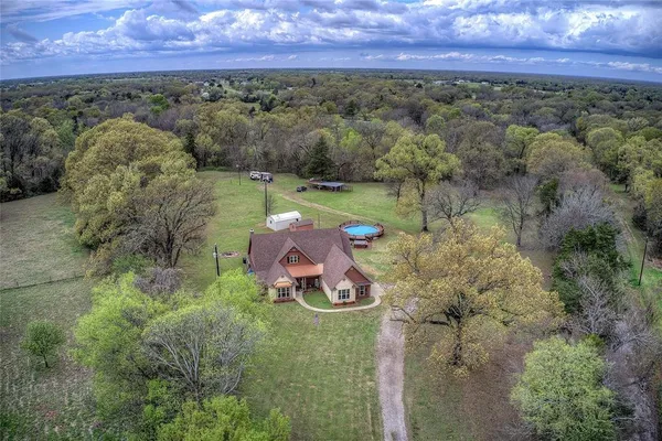 an aerial view of a house with a yard
