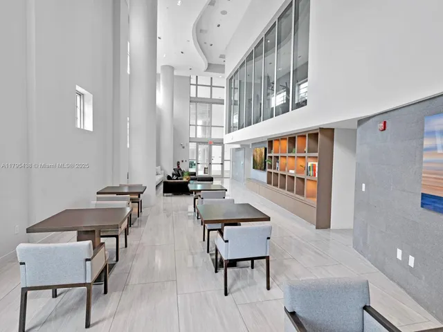 a living room filled with furniture and a potted plant