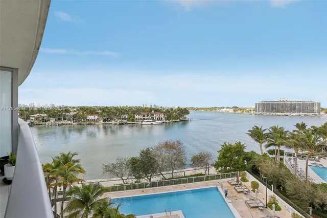 a dining room with furniture and a floor to ceiling window