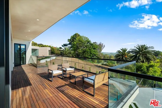 a living room with furniture a fireplace and a chandelier