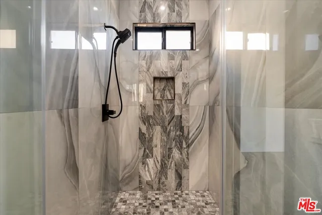 a bedroom with a large bed and a large window