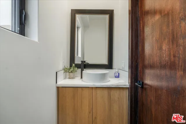 a bathroom with a double vanity sink and a mirror