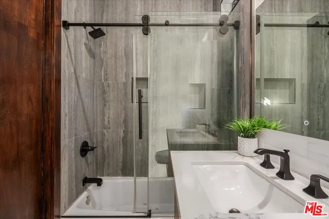 a bathroom with a shower and a sink