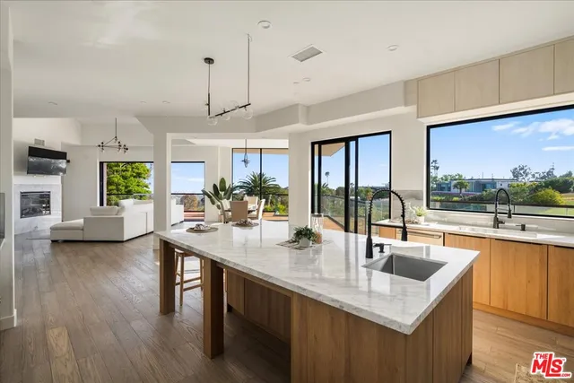 a kitchen with sink attached with living room