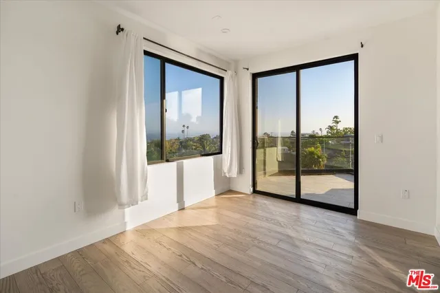 a view of an entryway with wooden floor