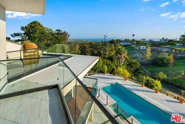 a spacious bedroom with a large bed and a large window