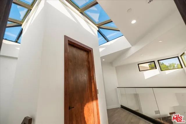 a kitchen with stainless steel appliances granite countertop a sink a stove and a wooden floors