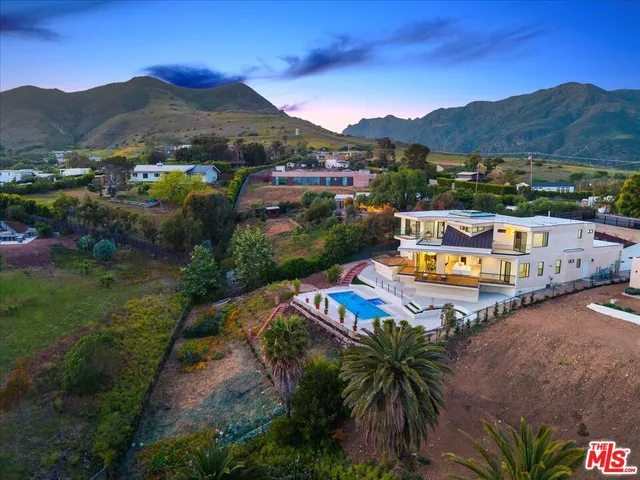 a kitchen with a table chairs refrigerator and microwave