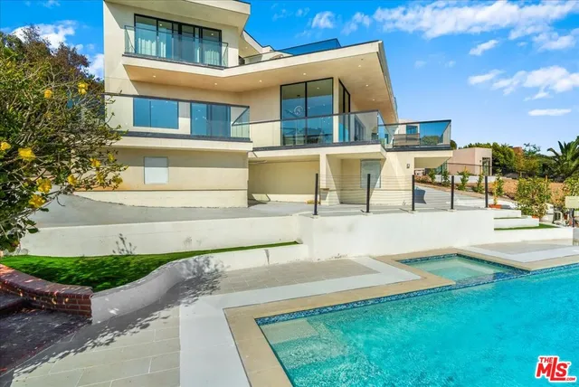 a kitchen with stainless steel appliances granite countertop a stove a refrigerator a sink dishwasher a dining table and chairs with wooden floor