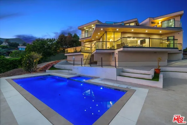 a kitchen with stainless steel appliances granite countertop a sink and a refrigerator