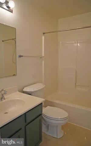 a view of a bathroom with toilet cabinet and a window