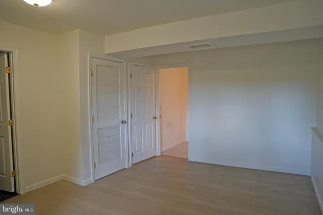 a balcony with wooden floor and fence