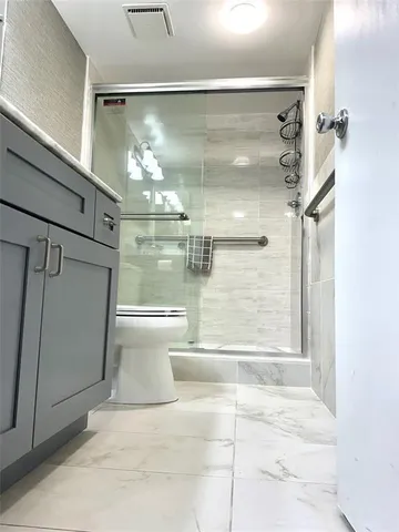 a living room with furniture a table and chairs next to a window