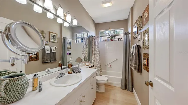 a living room with furniture a large window and a flat screen tv