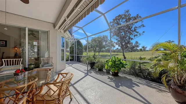 a view of a park bench and a fountain in the background