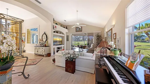 a living room with furniture fireplace and a large window