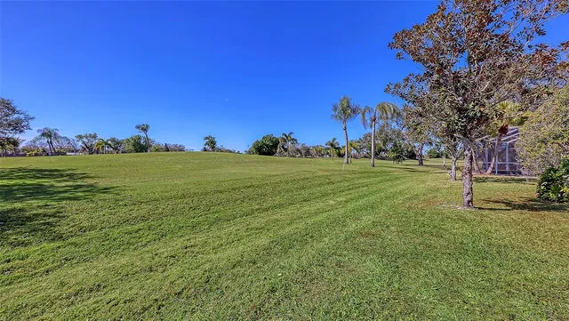 a living room with wooden floors furniture and kitchen view