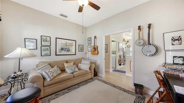 a living room with furniture a chandelier and a lamp